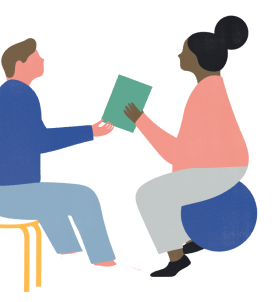 Two team members exchanging a book and chatting.